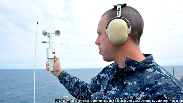 photo of aerographer taking a wind direction using an anemometer