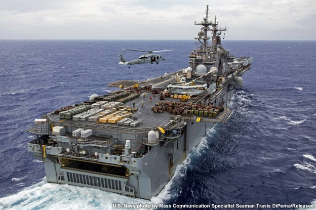 photo of the USS Kearsarge under sail with helicoptor operations in progress