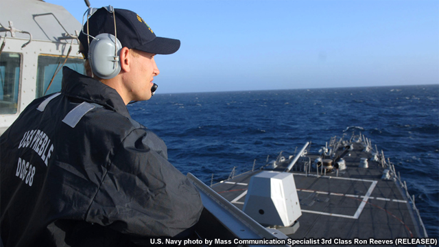 Seaman Nicholas Pennington stands watch from the pilot house aboard the Arleigh Burke-class guided missile destroyer USS Preble (DDG 88). 