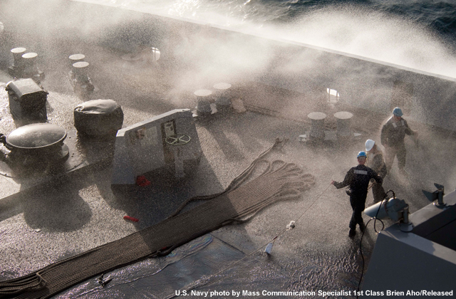 Sea spray washes over the deck