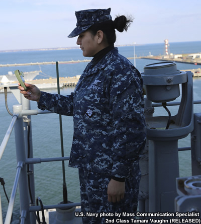 photo of aerographer's mate taking temperature observation aboard the USS Kearsarge