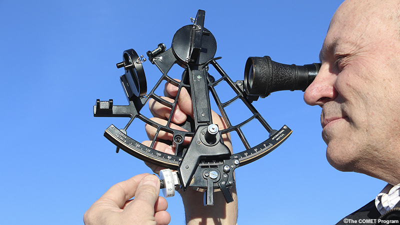 photo of navigator using sextant to take a sight