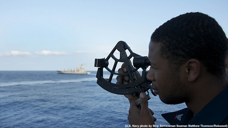 Quartermaster 3rd class Hank Golden uses a sextant aboard the guided-missile destroyer USS Jason Dunham.