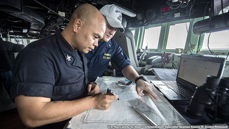 Lt. j.g. Colcord Moore, from Boston, Mass., and Quartermaster 1st Class Howell Trinidad, from Long Beach, Calif., discuss navigation charts in the pilot house of the Arleigh Burke-class guided-missile destroyer USS Stethem (DDG 63). 